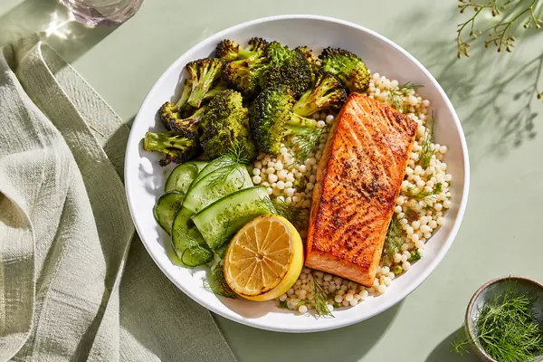 A salmon bowl with grains, greens and lemon